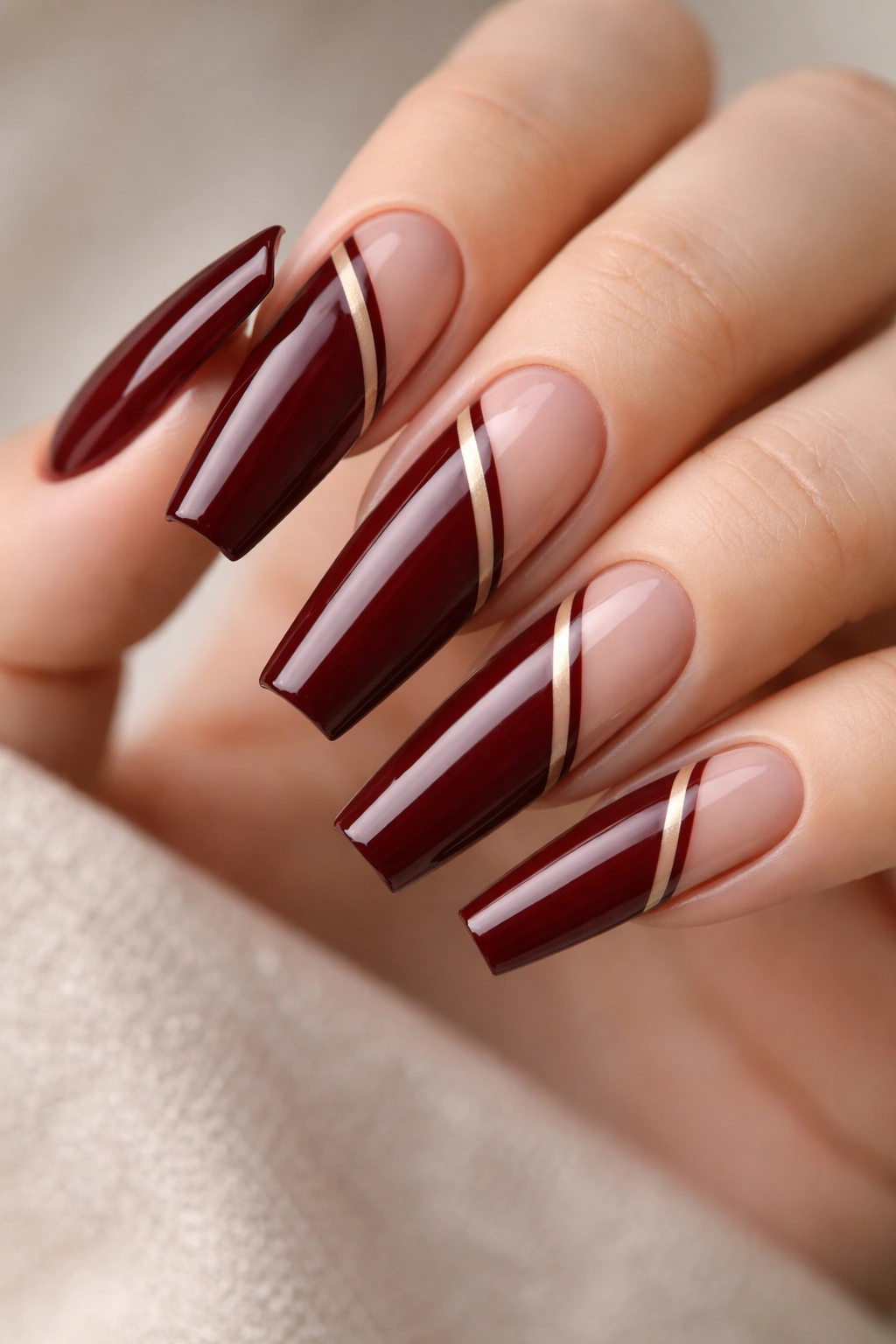 Coffin nails with dark red polish and thin negative-space lines