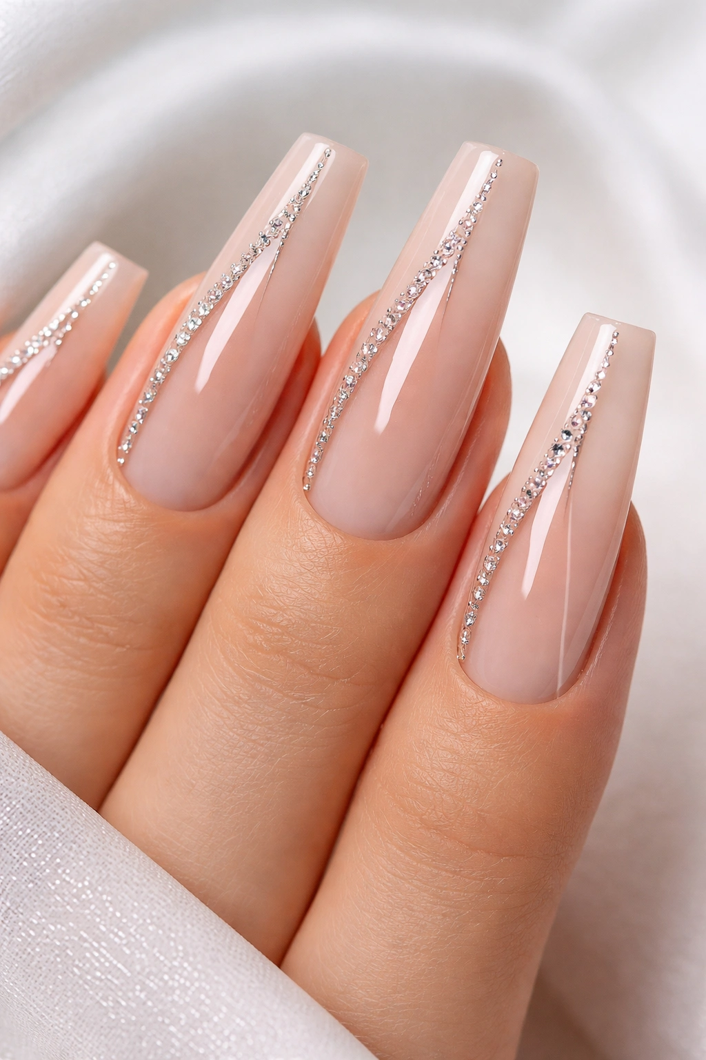 Nude nails with geometric crystal lines forming negative space panels