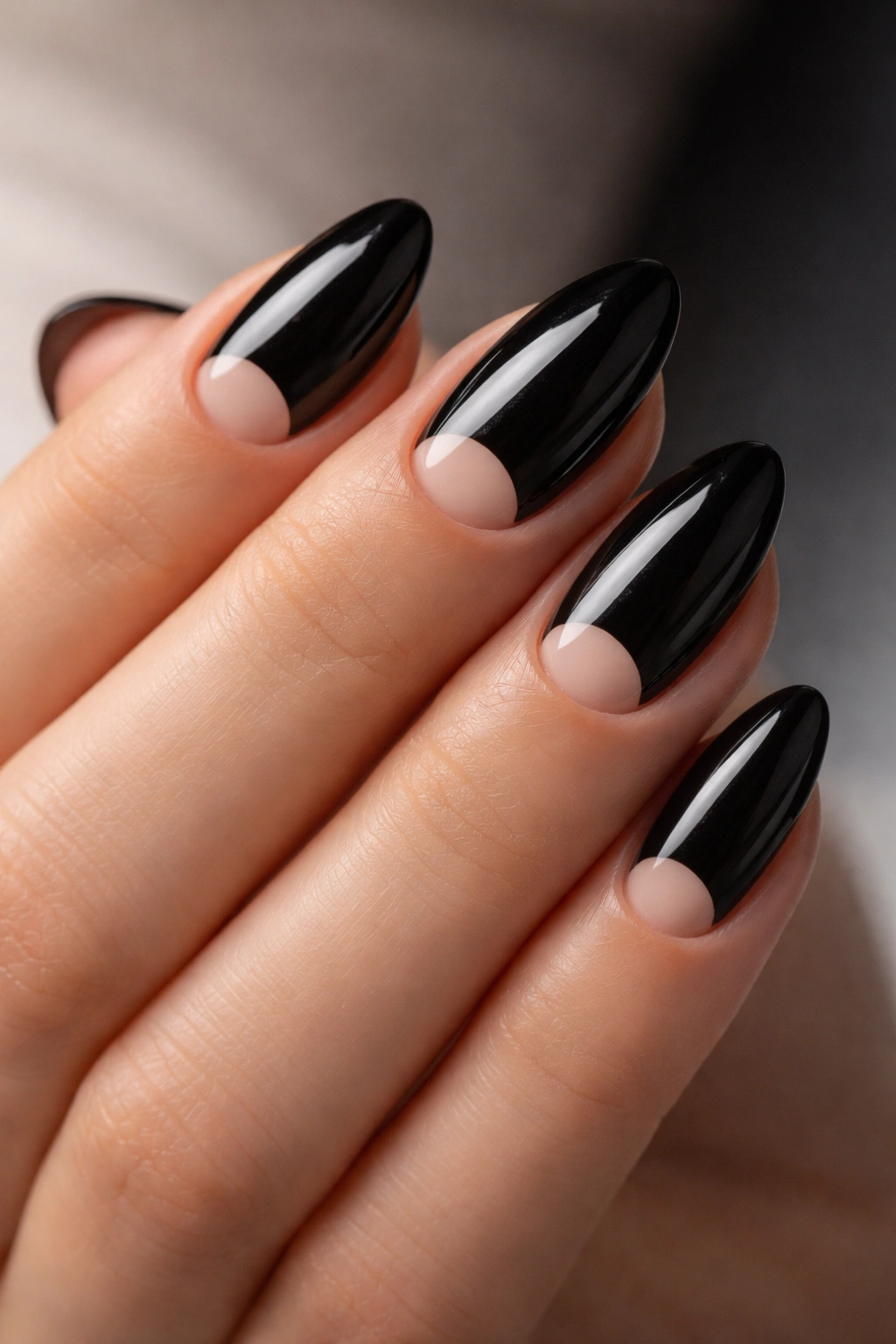 Close-up of black almond nails with a bare cuticle space