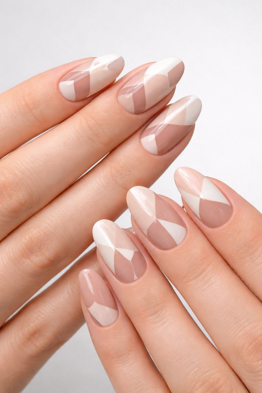 Geometric negative-space gel nails on both hands with matching patterns