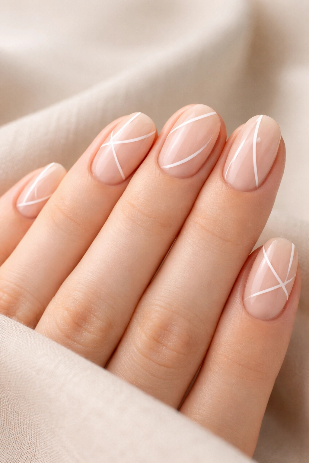 Close-up of nails with negative space nail art showing bare areas