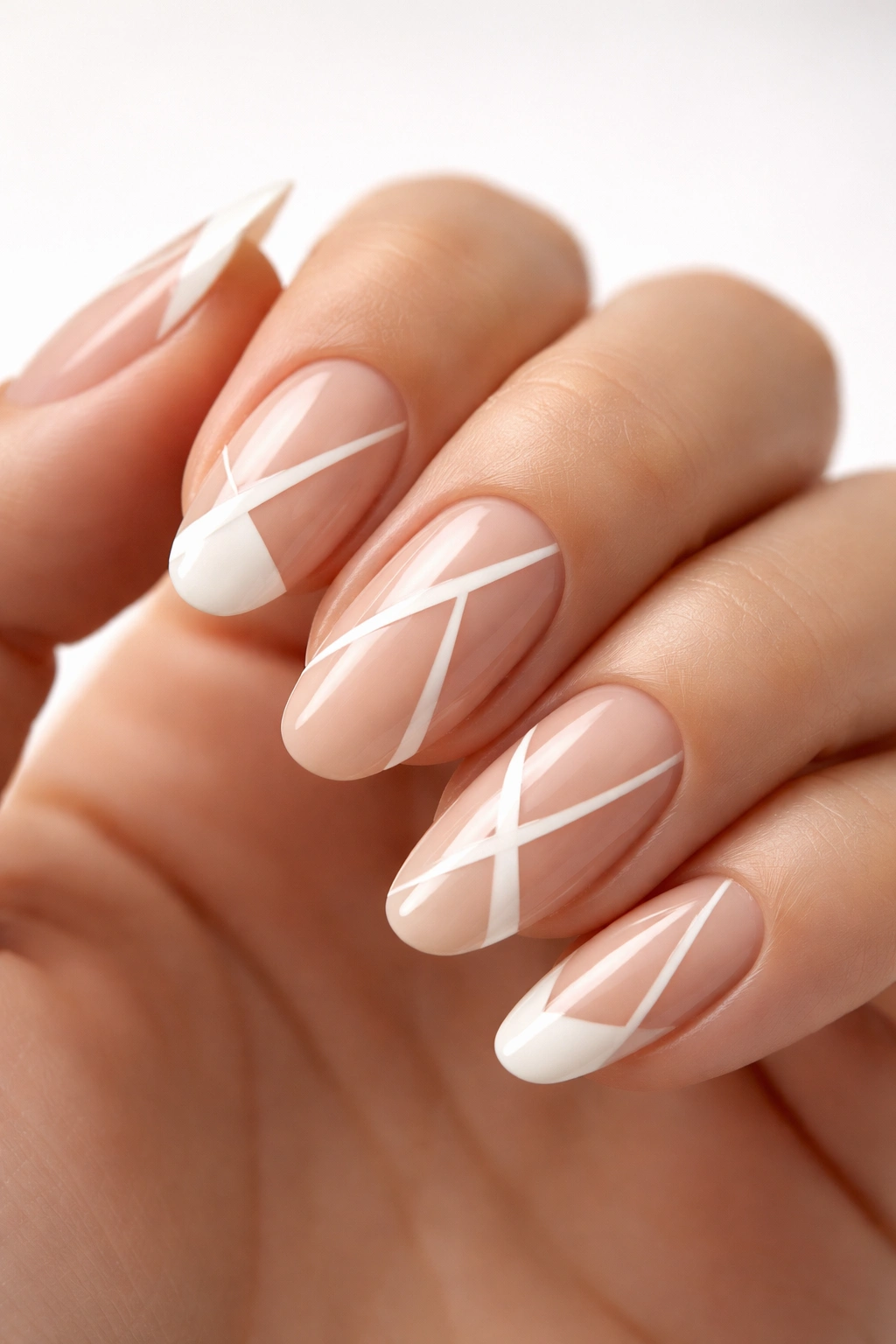 Nails with negative-space geometric nail art on natural nail