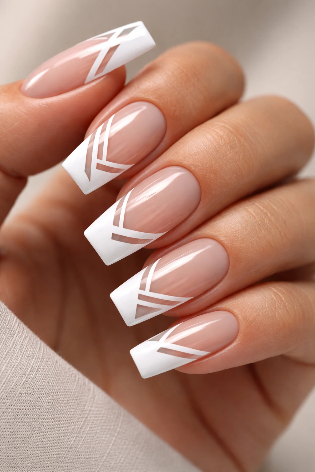 Close-up of negative-space geometric French tips on medium coffin nails