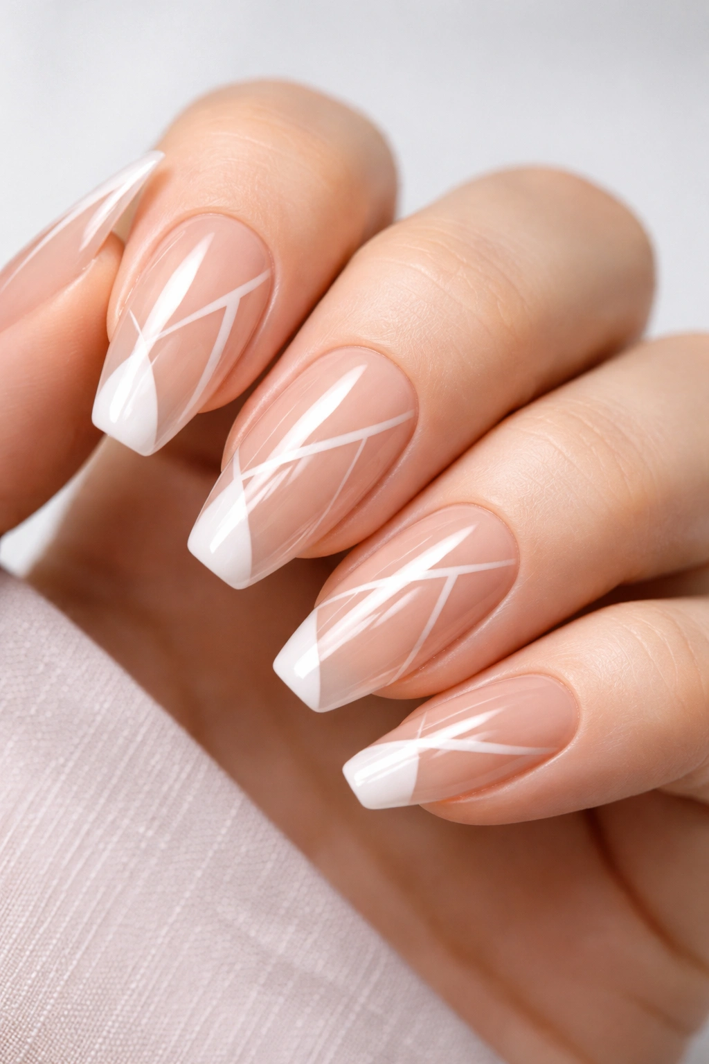 Acrylic nails with geometric negative space cutouts on nude base