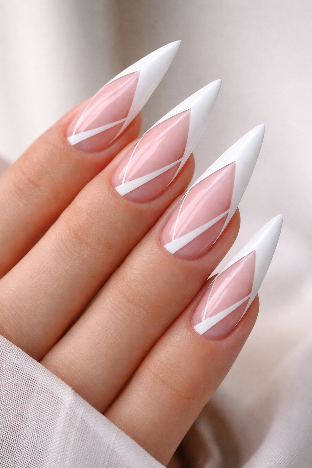 Close-up of nails with negative-space pink shapes inside white French tips