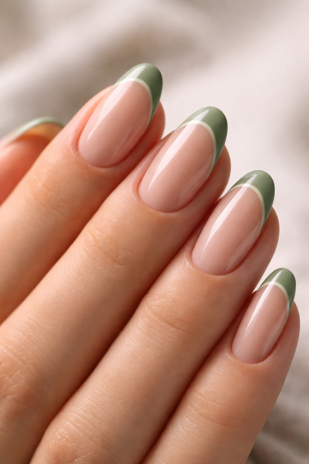 Short almond nails with sage tips using negative space and bare nail areas