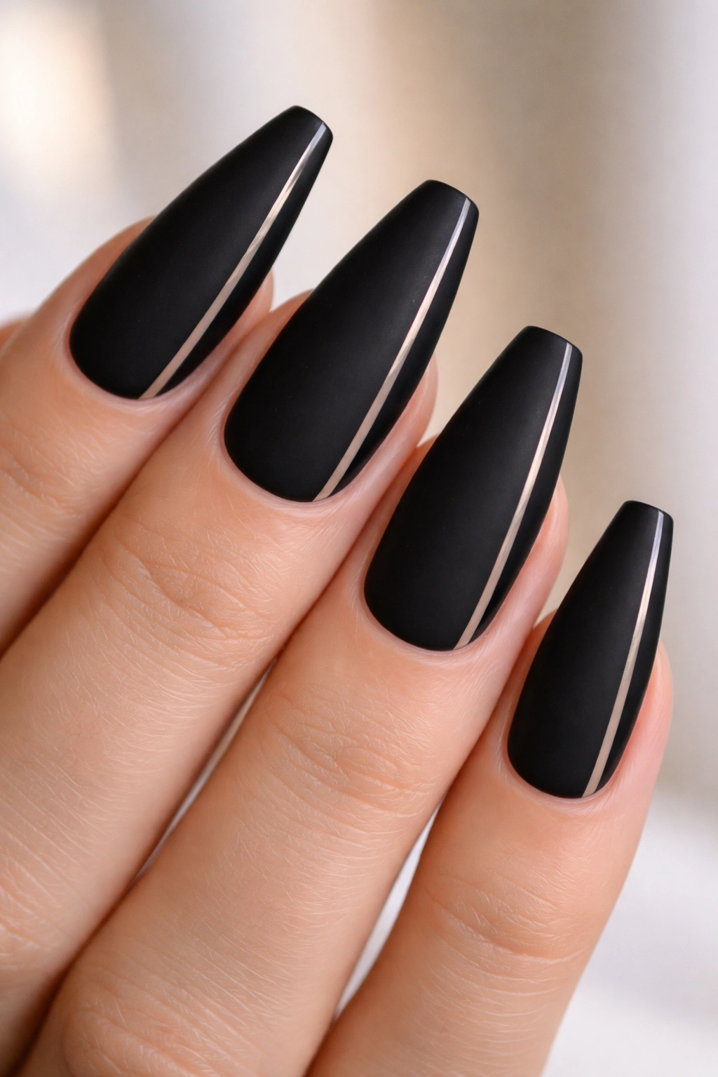 Matte black nails with a thin side stripe negative space along the edge.