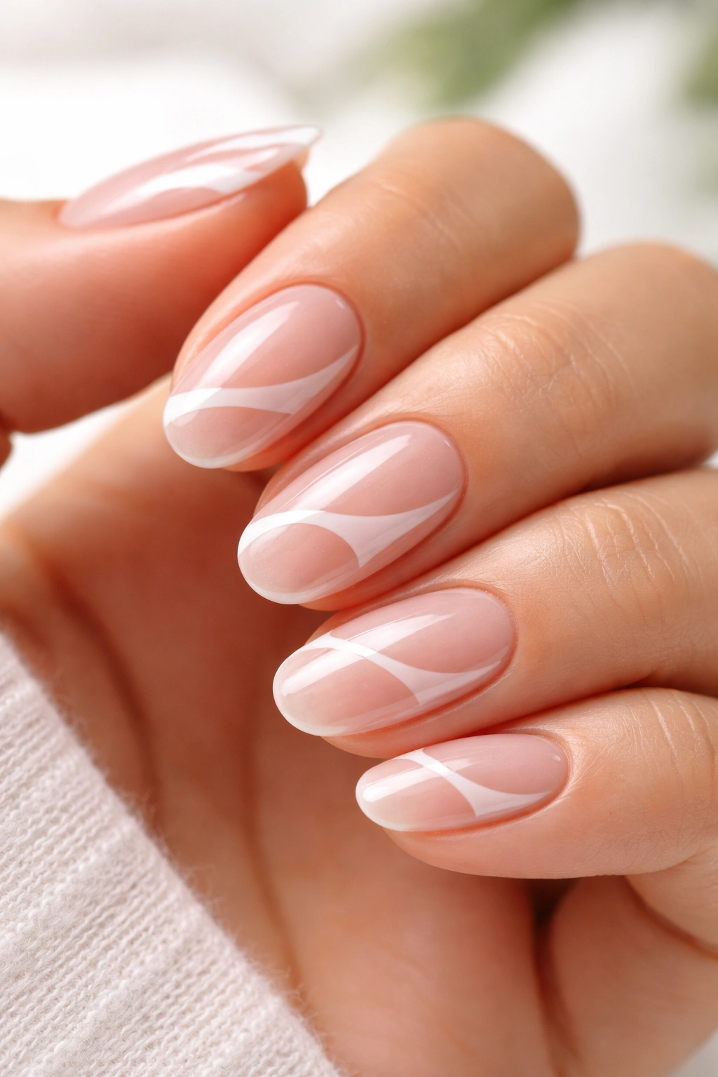 Close-up of negative space short oval builder gel nails with clear cutouts