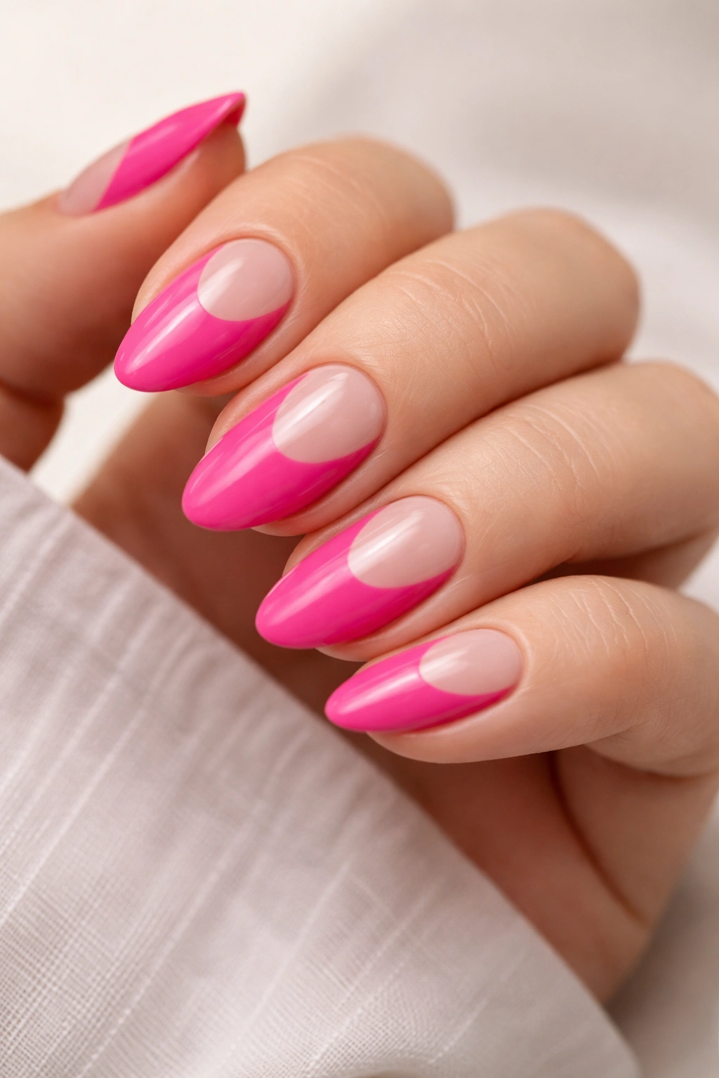 Hot pink almond nails with negative space cutouts on short nails