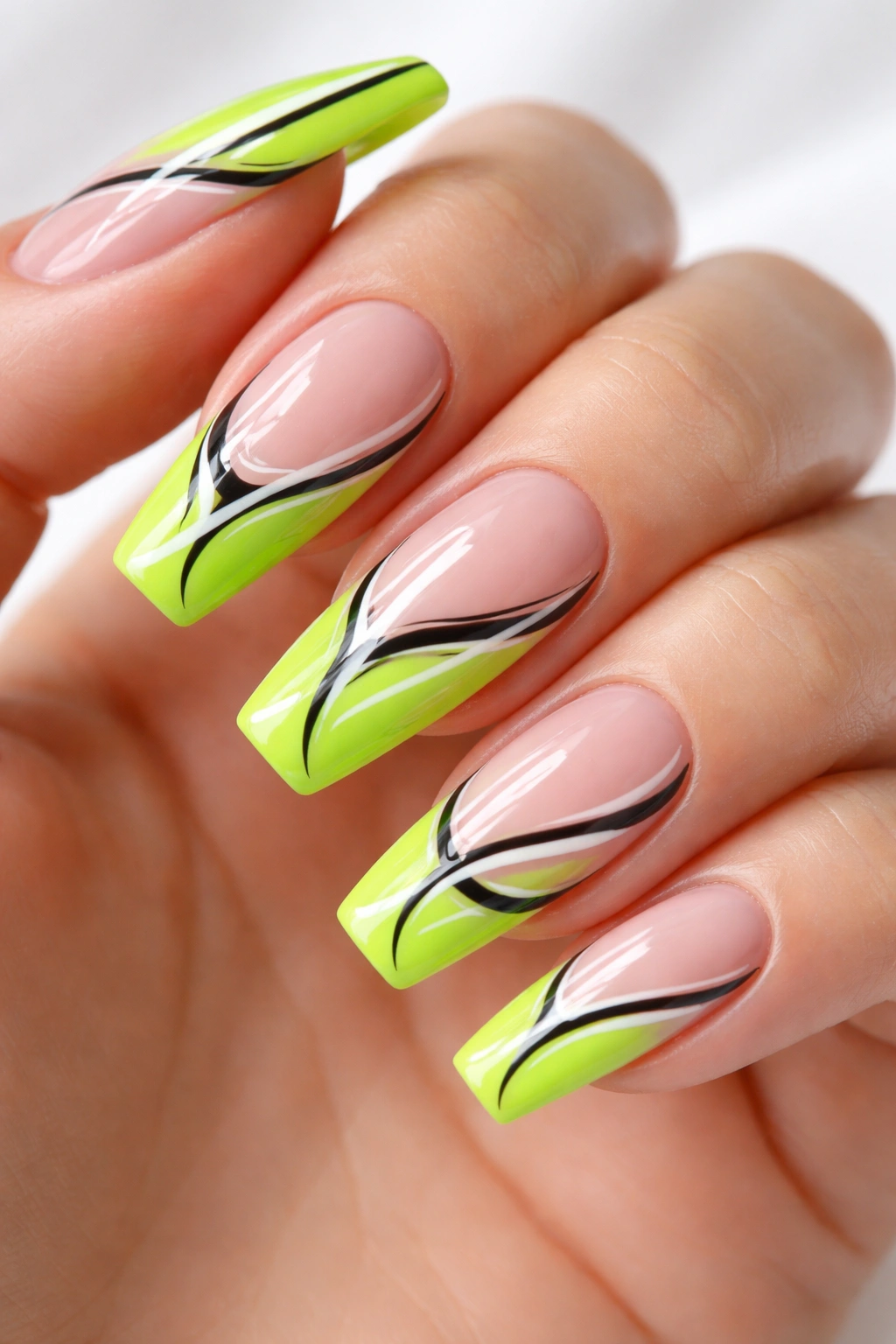 Close-up of neon green French manicure with abstract lines on nude nails, almond-shaped tips.
