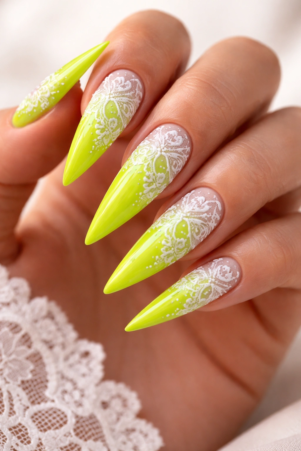 Neon lime nails with white lace patterns close-up