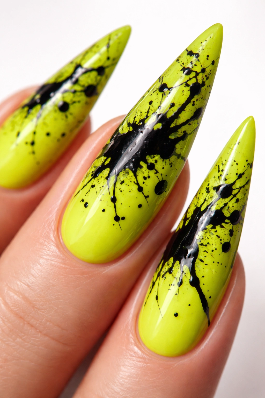 Lime neon stiletto nail with black splatter