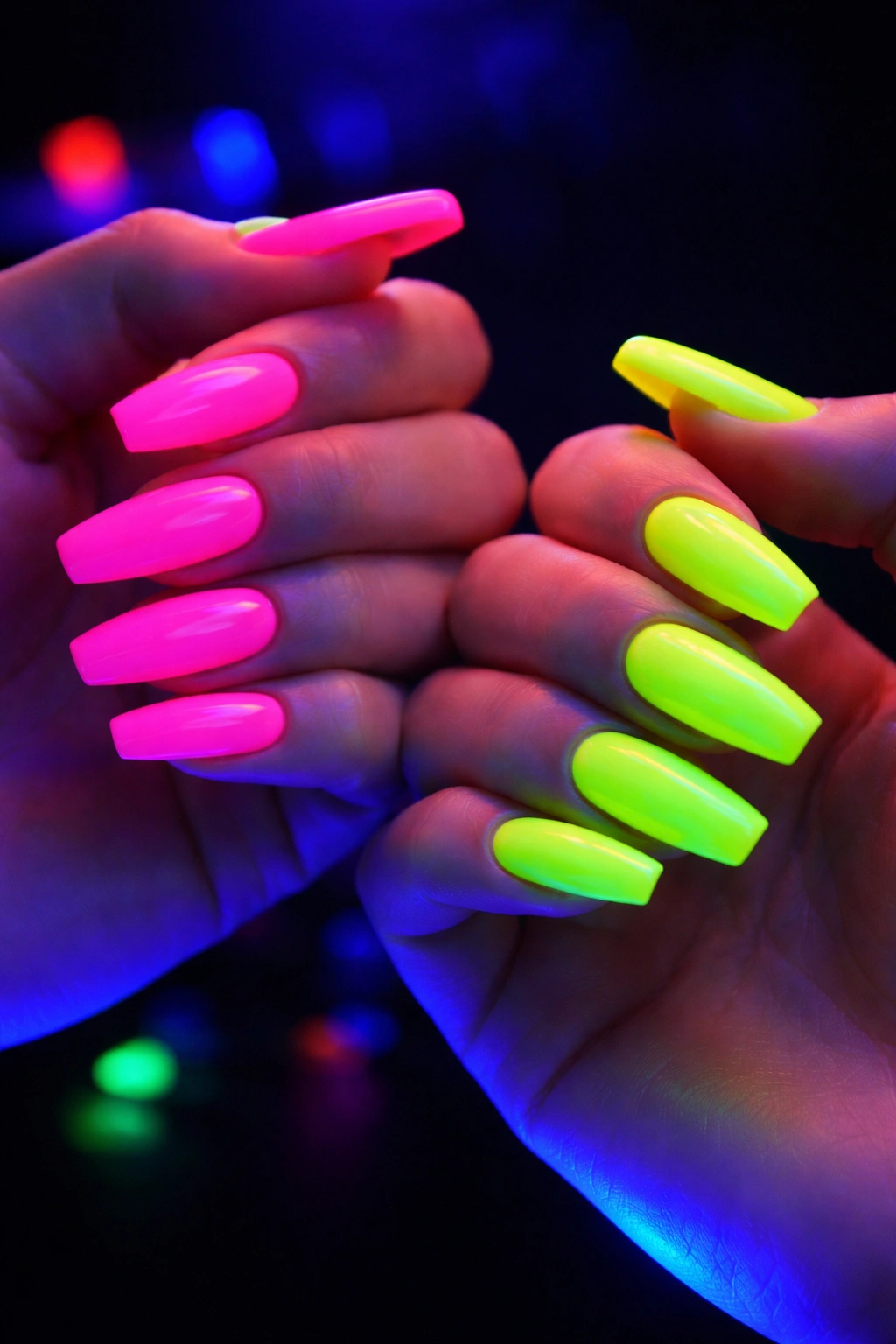 Hands with neon acrylic nails glowing under blacklight