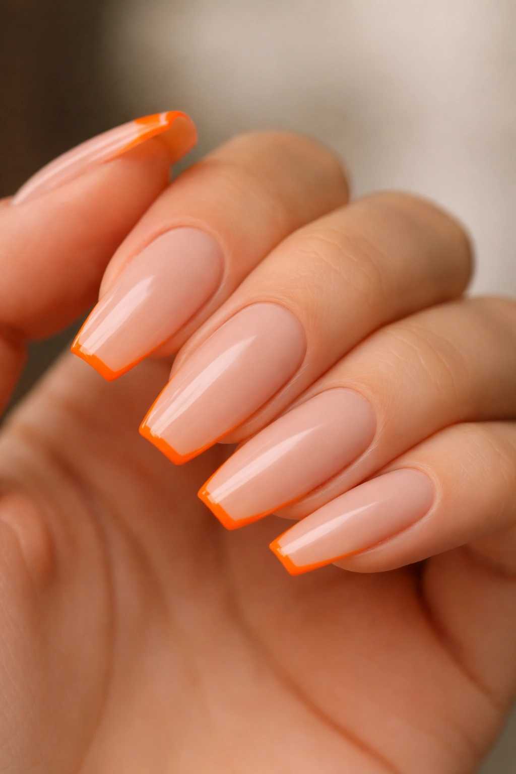 Neon orange micro French on ballerina nails with nude base