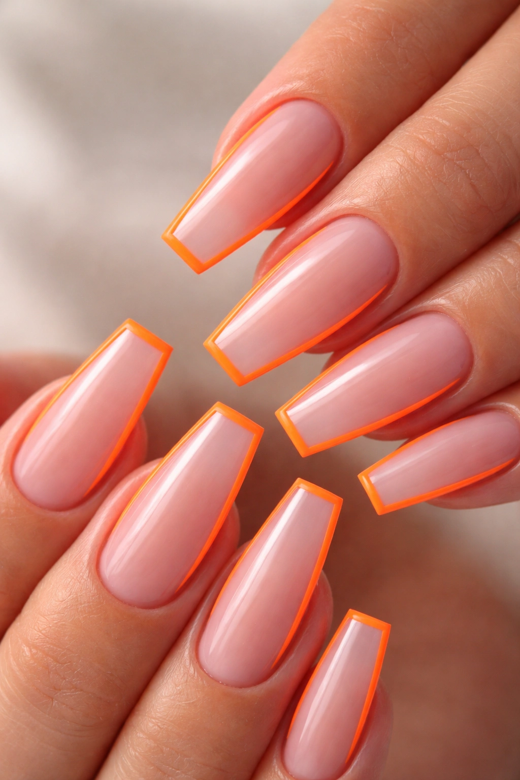 Neon orange outline nails with negative space on ballerina shape