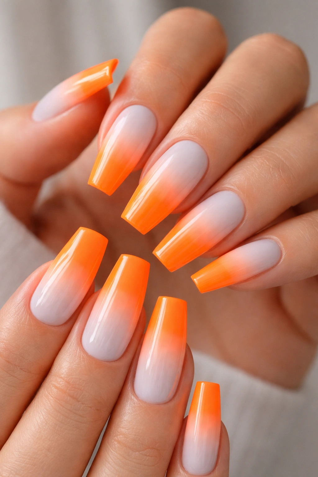 Coffin nails with white-to-neon orange reverse ombre