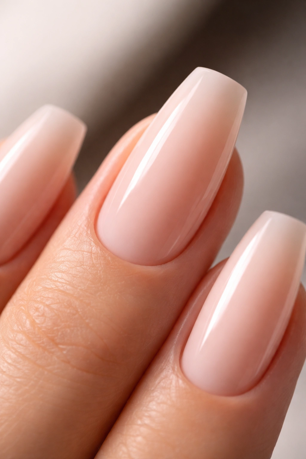 Close-up of neutral ballerina nails showing precise shape and smooth finish