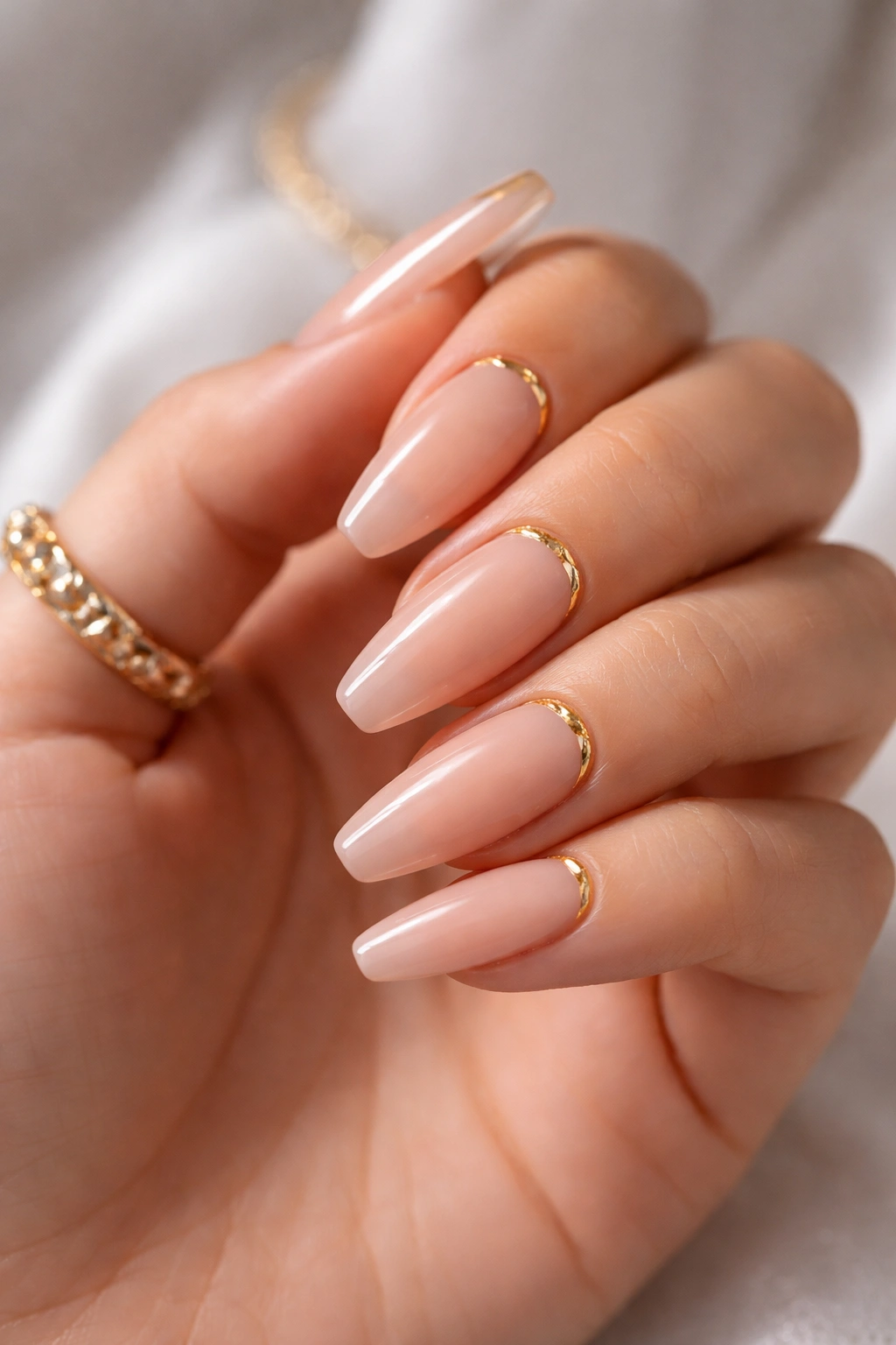 Nude ballerina nails with gold cuticle foil crescent accents