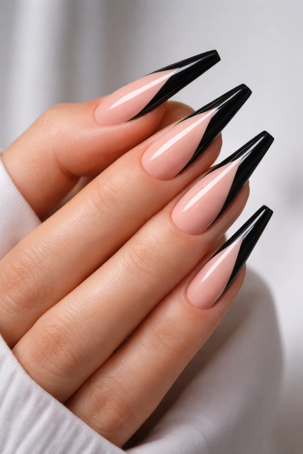 Nude base coffin nails with precise black cat eye lines