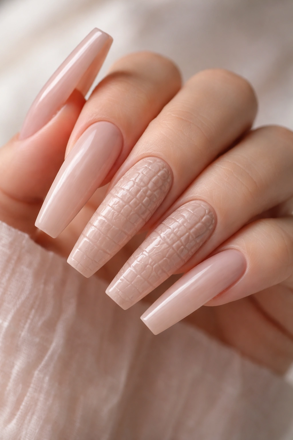 Nude ballerina nails with crocodile texture on middle and ring fingers