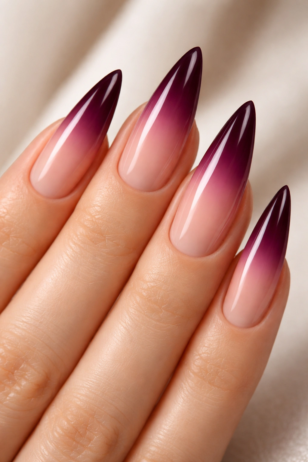 Stiletto nails with nude to plum gradient
