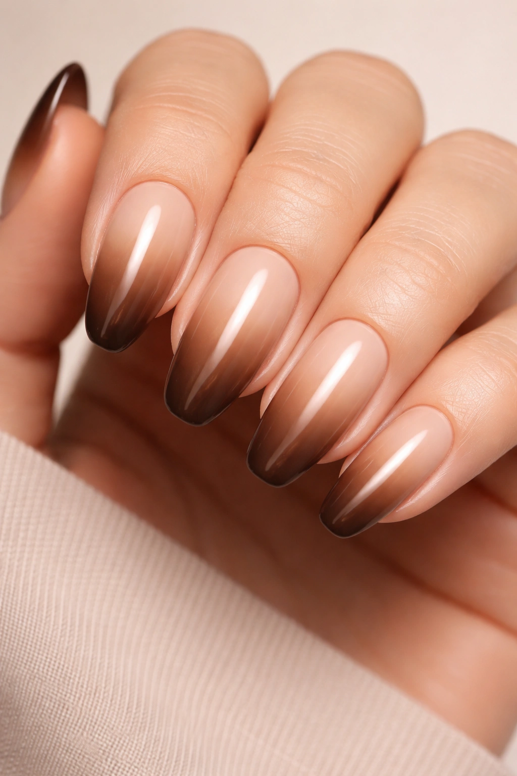 Close-up of nails with a nude to mocha gradient