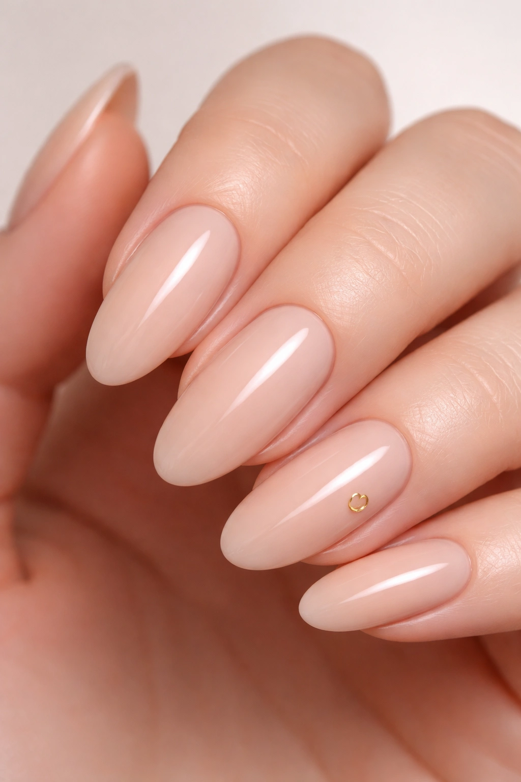 Nude nails with a tiny glyph on one nail