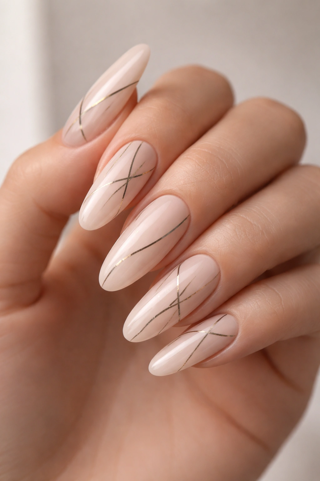 Close-up of nude nails with minimalist abstract line art