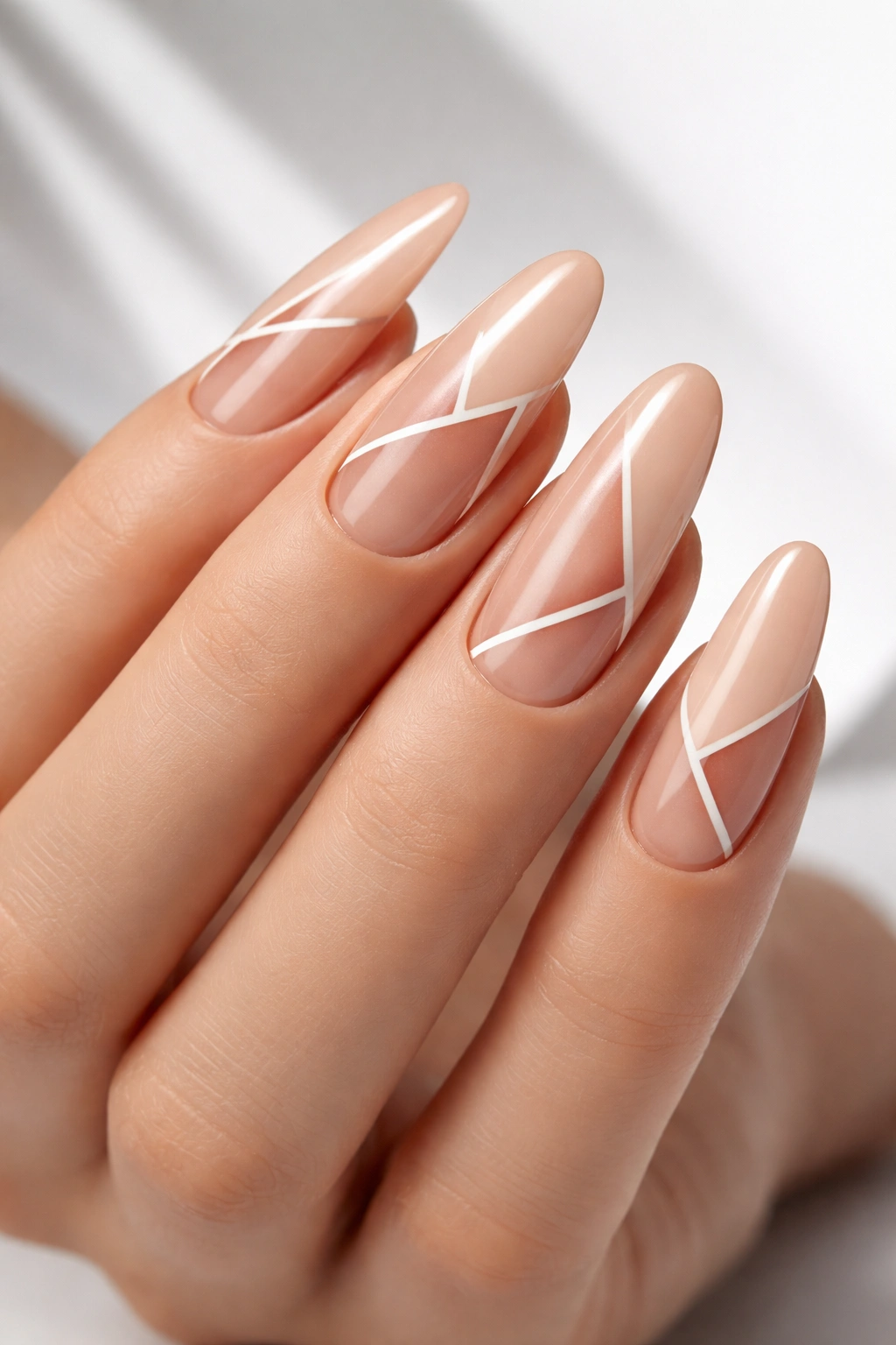 Nude long oval nails with geometric negative-space shapes