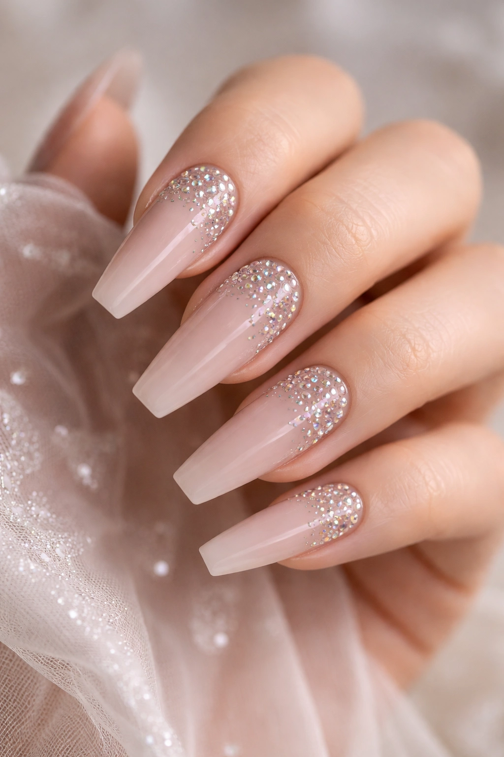 Nude coffin nails with a rhinestone gradient from base to tip