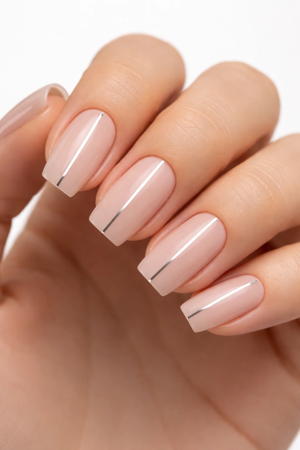 Short coffin nails with nude base and a single silver line