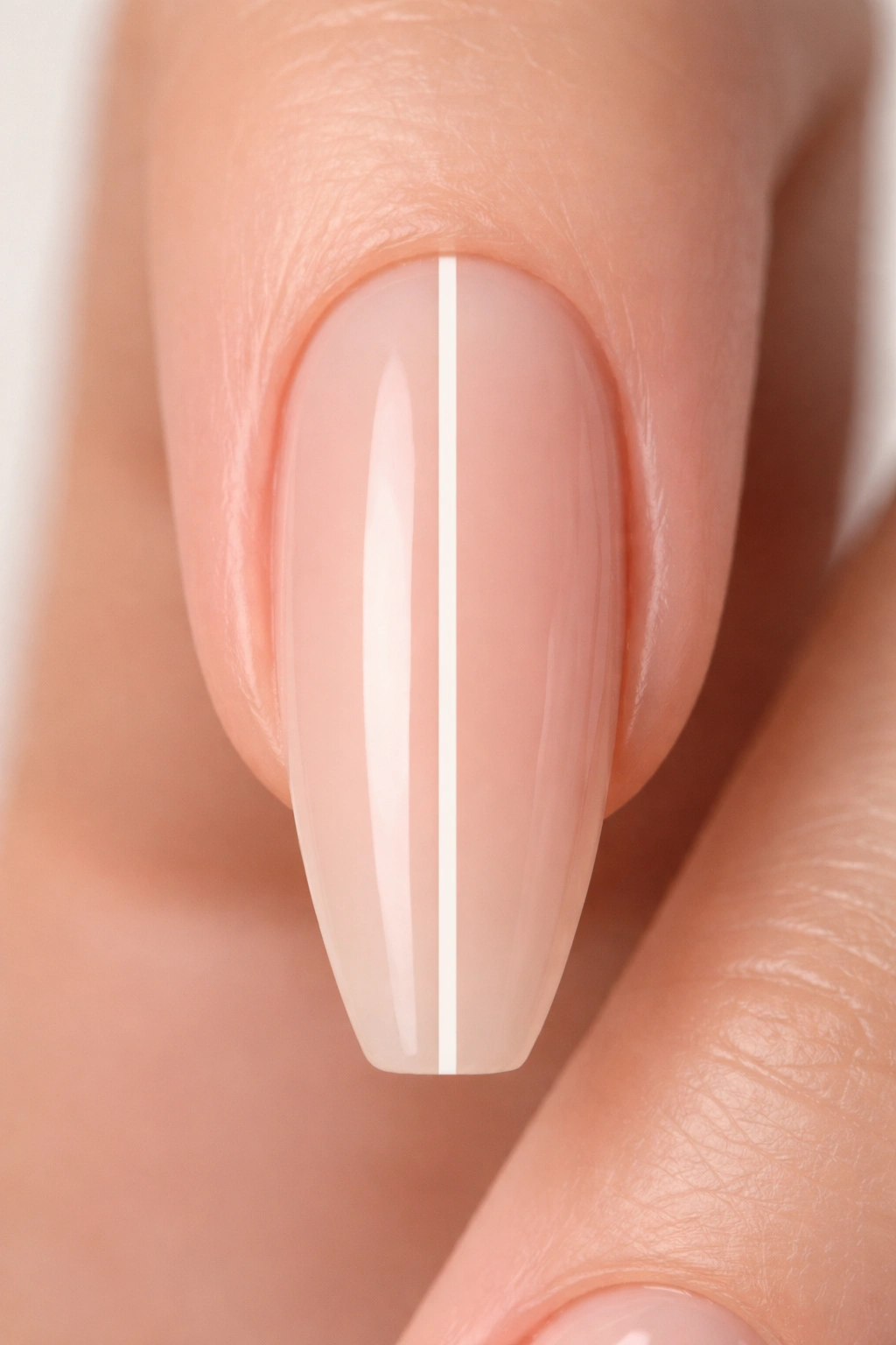 Close-up of nude ballerina nail with centered white vertical stripe