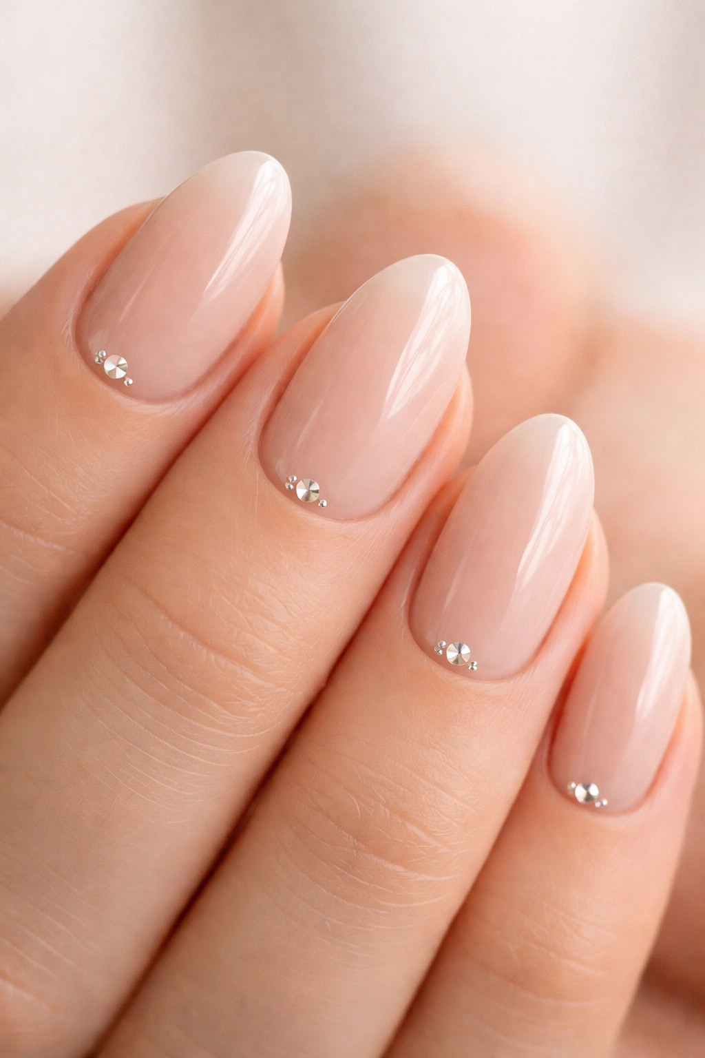 Short almond nails with tiny crystals at the cuticle line