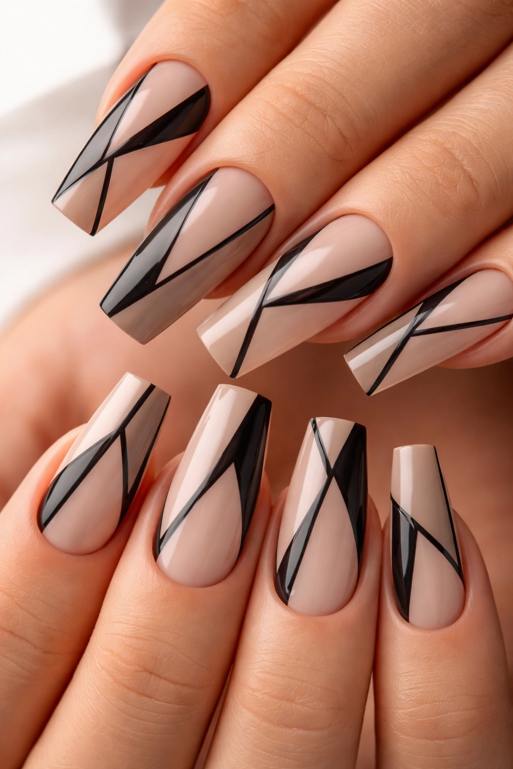 Close-up nude nails with negative-space geometric pattern