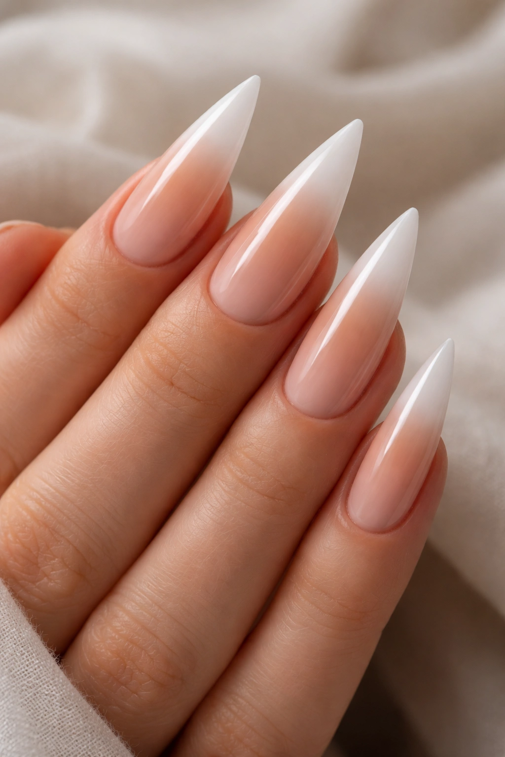 Close-up of stiletto nails with nude ombré French tip