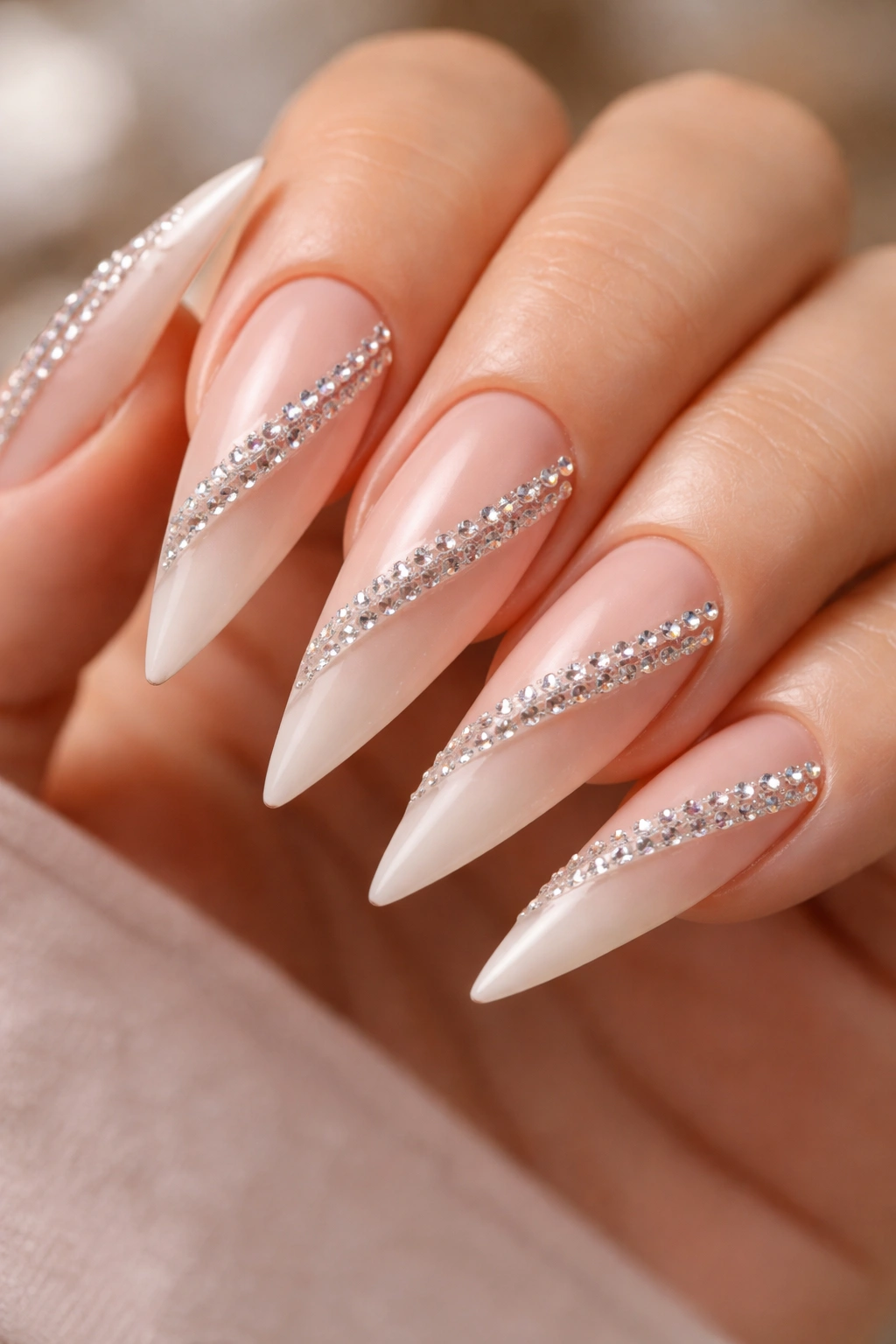 Nude ombre nails with parallel rhinestone lines