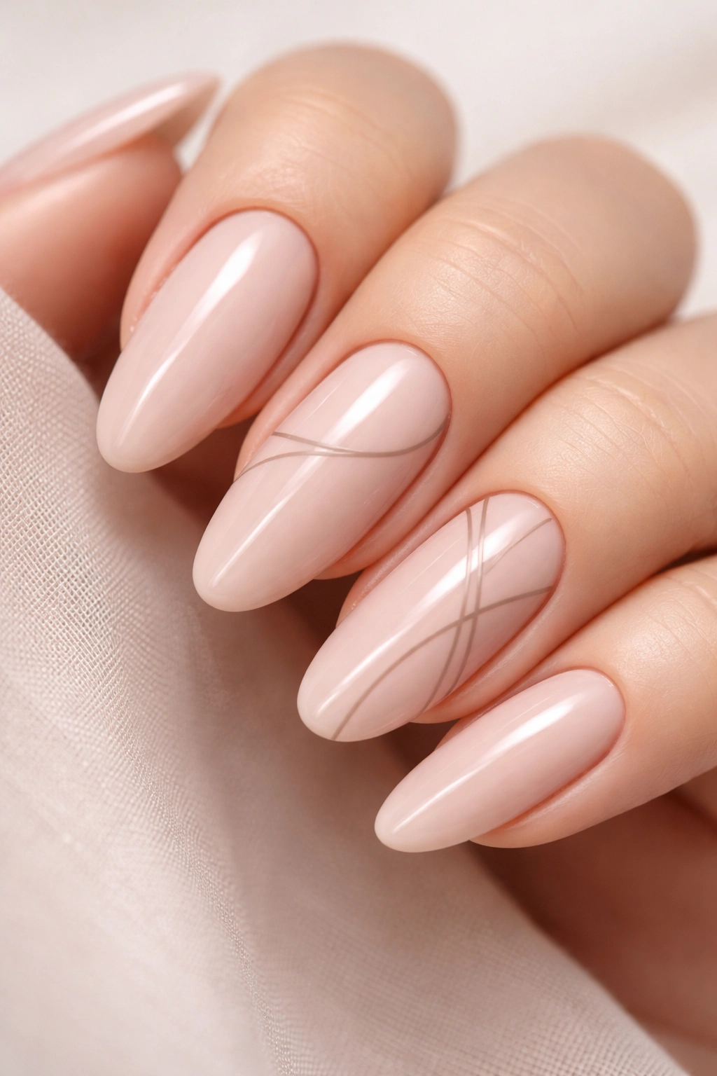 Close-up of nude pink nails with minimalist taupe line art