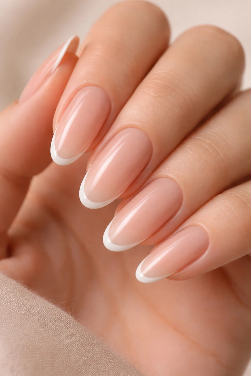 Close-up of long oval nails with an ultra-thin French outline