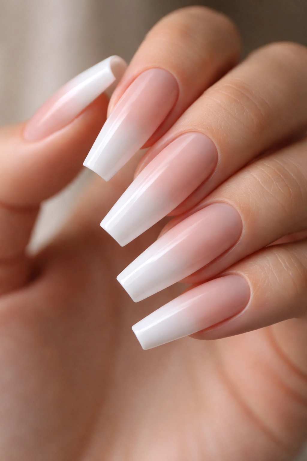 Nude-to-white ombre coffin nails with sponge gradient