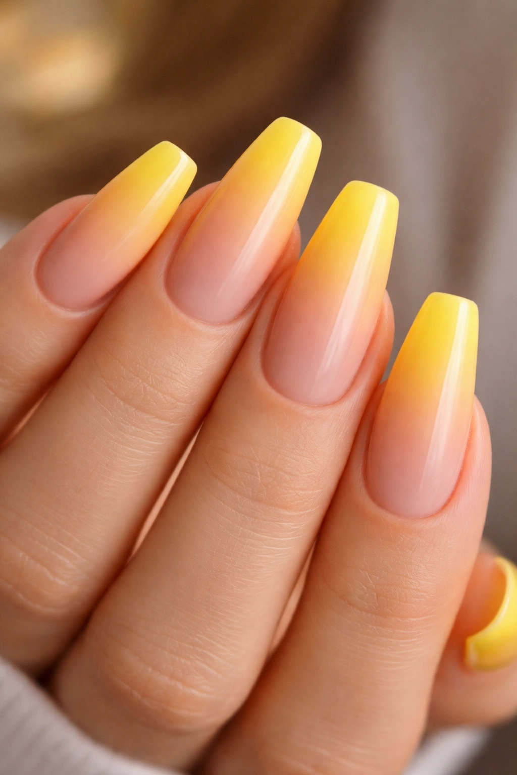 Nude-to-yellow ombré nails with smooth gradient from nude to yellow