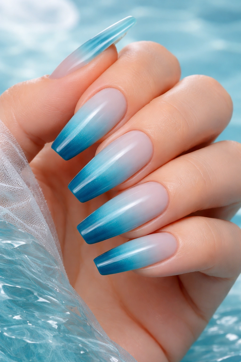 Close-up of coffin nails in blue to teal ocean-inspired ombre