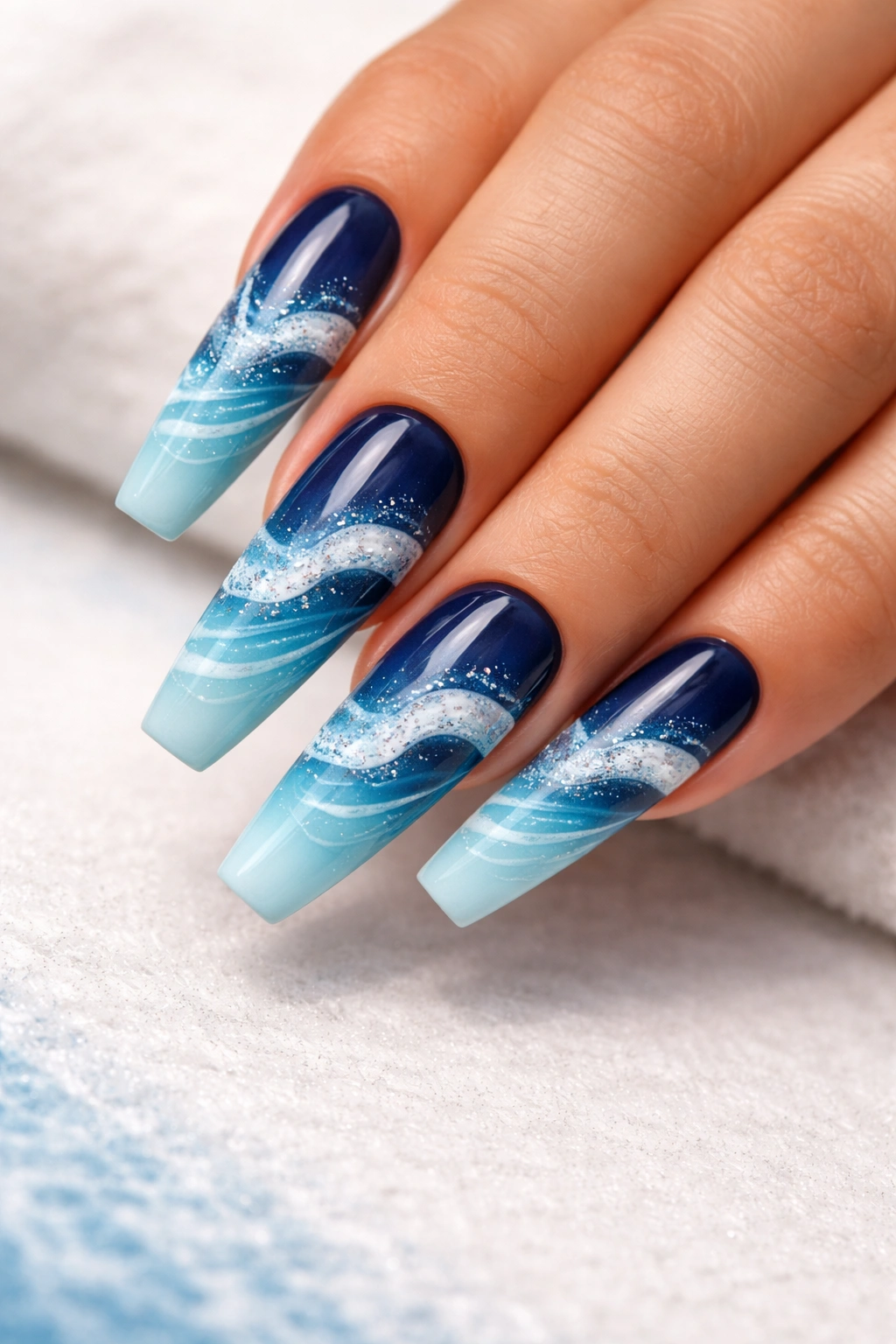 Coffin nails with ocean wave gradient from navy to turquoise and white wave details.