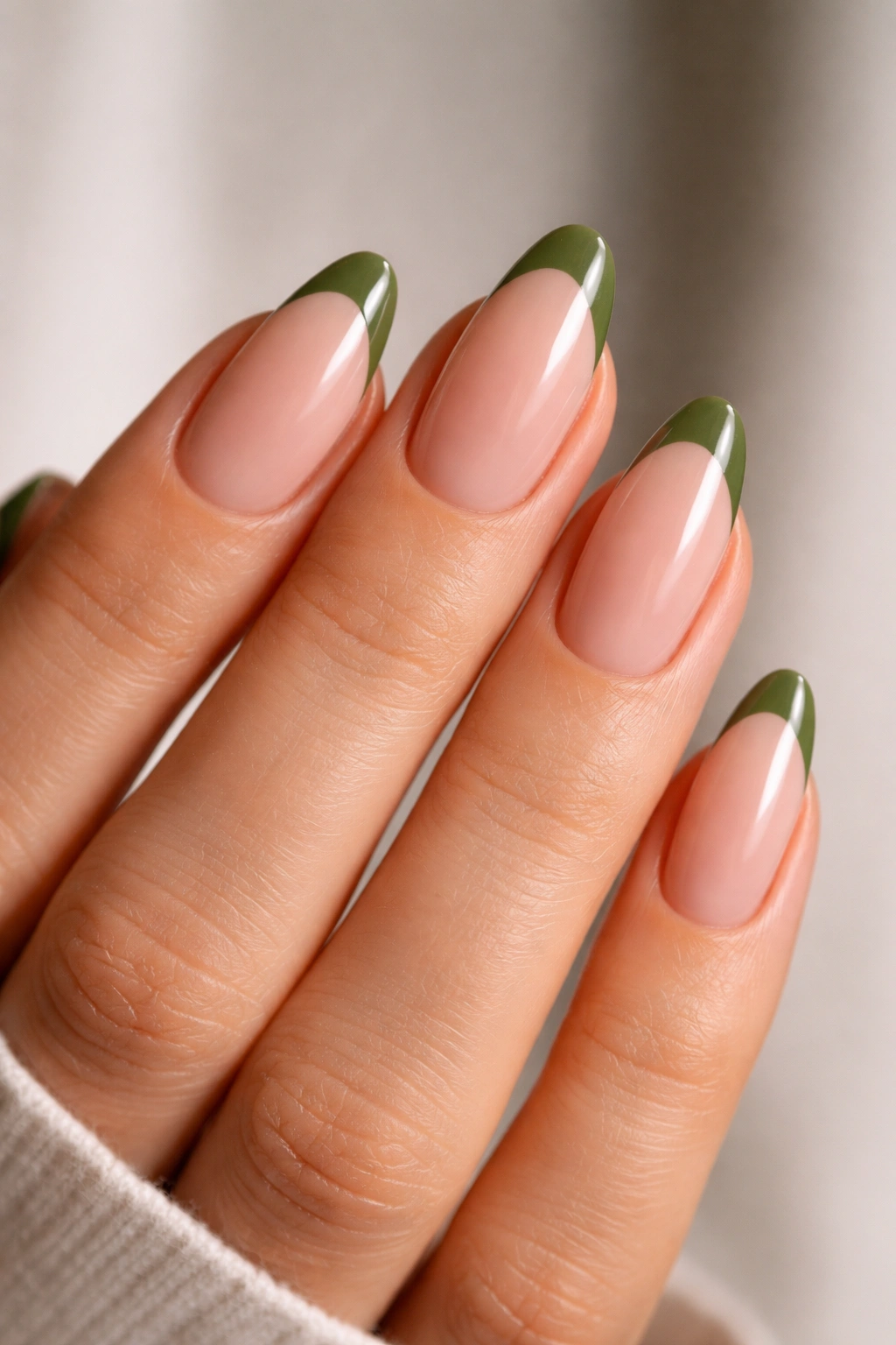 Olive green almond nails with nude base and olive tips