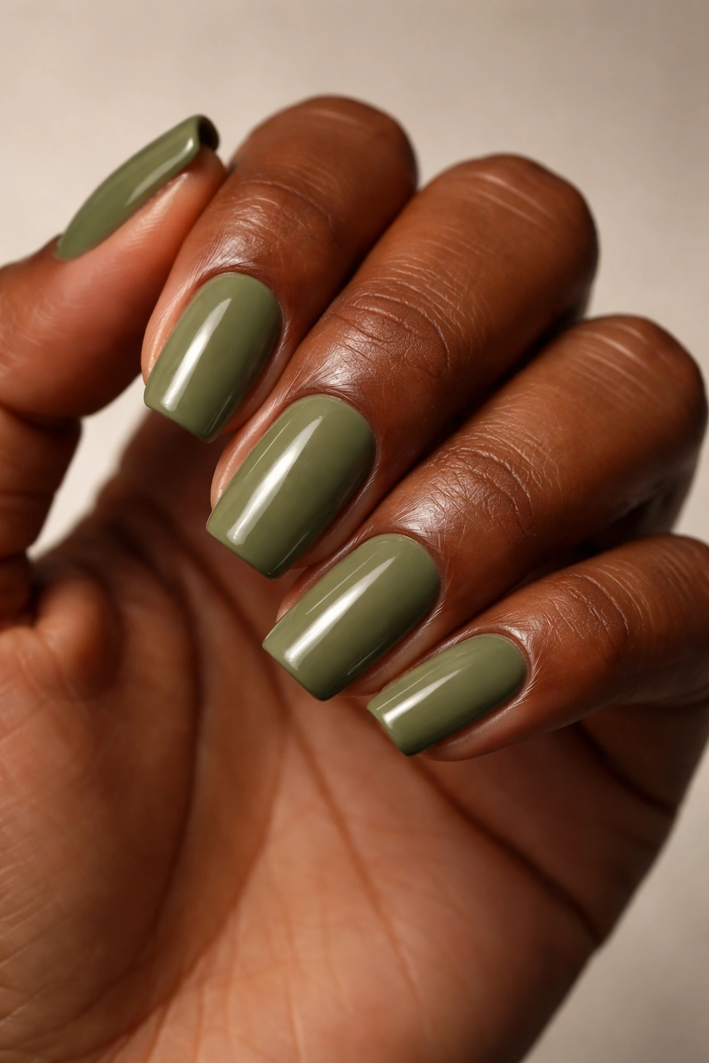 Dark skin with olive green nails