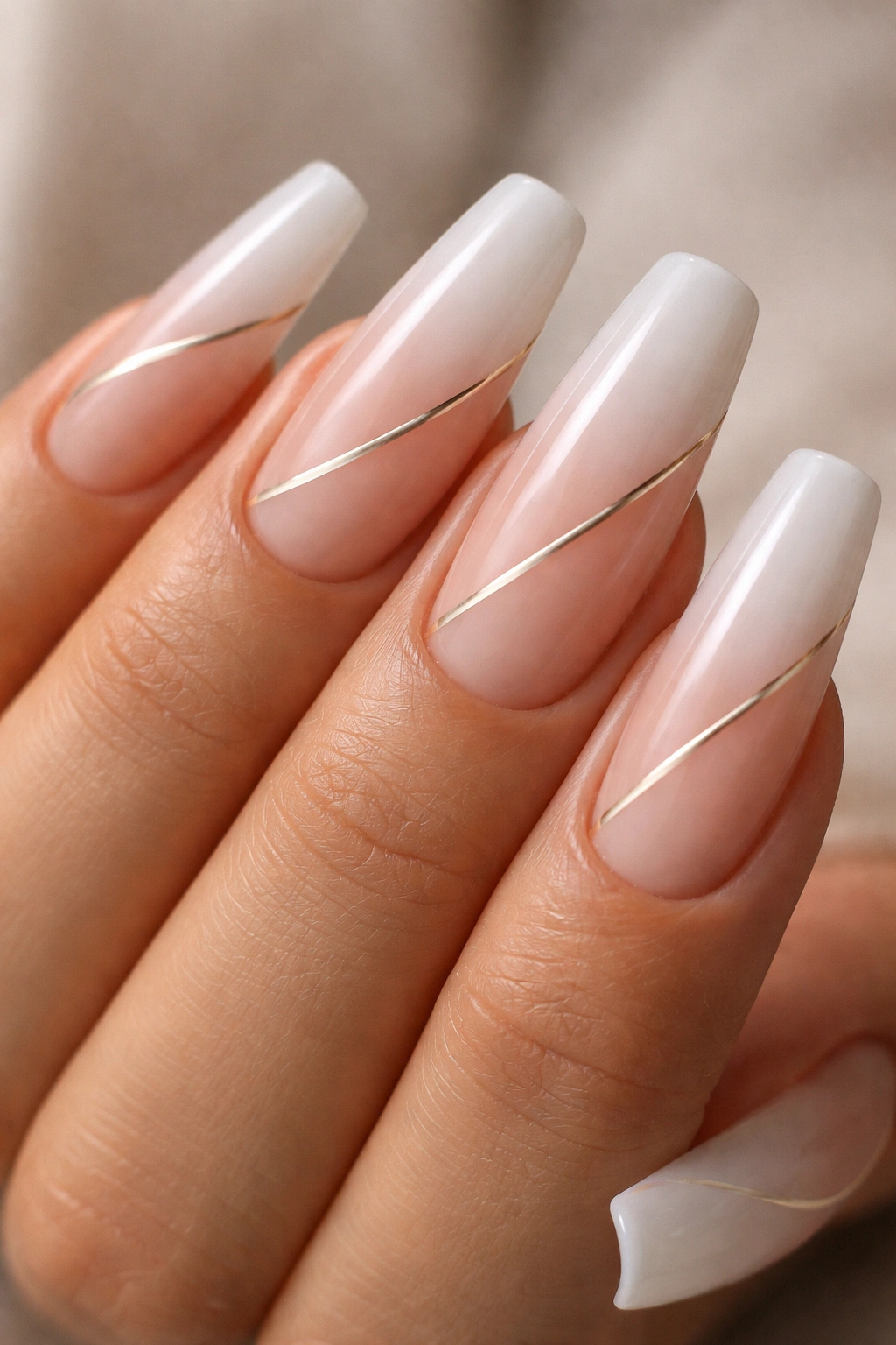 Nude-to-white ombré with a diagonal accent line on curved coffin nails