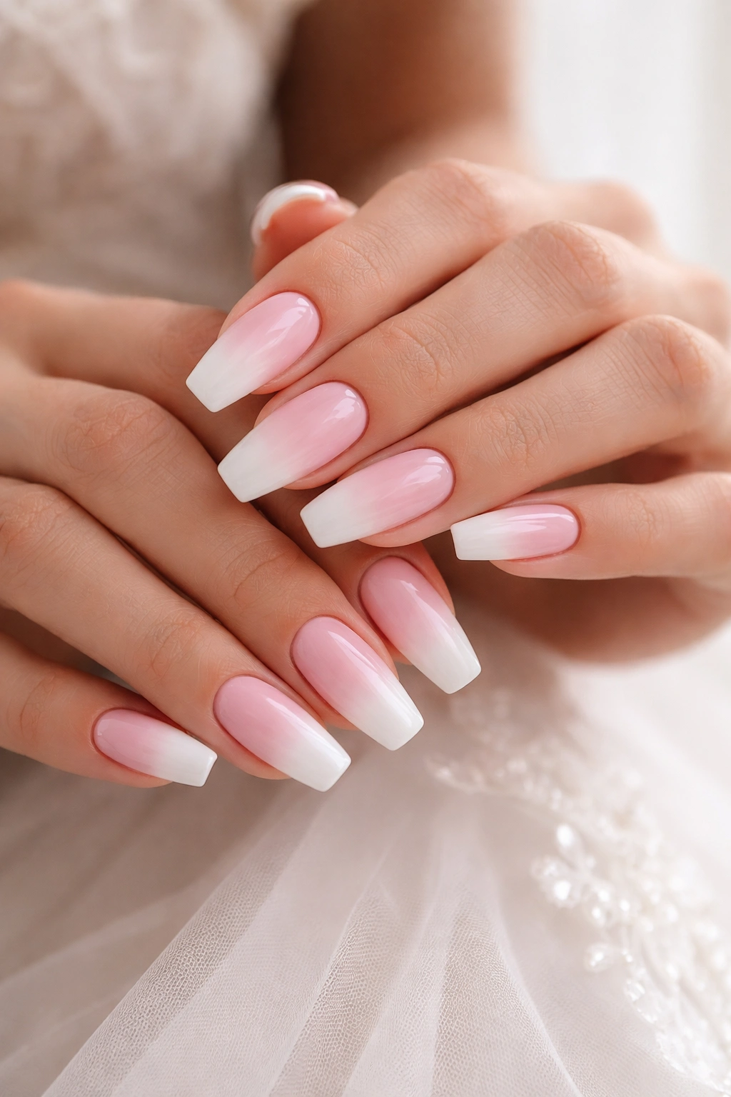 Close-up of hands with blush pink to ivory ombré on ballerina nails