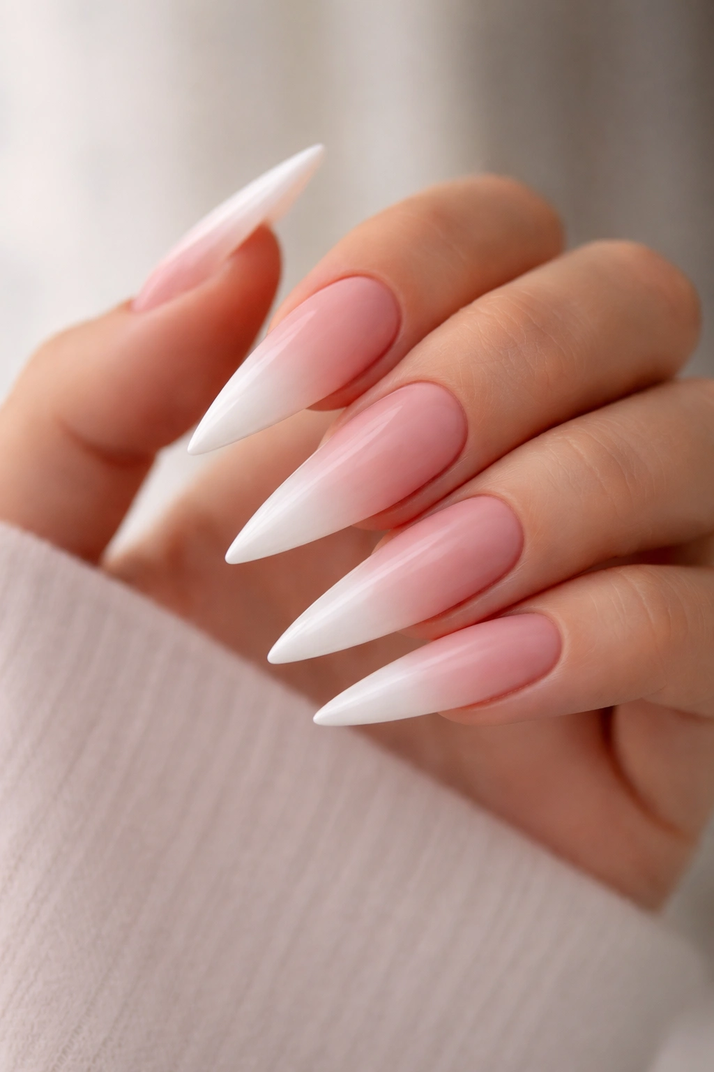 Ombre blush to white tip stiletto nails close-up