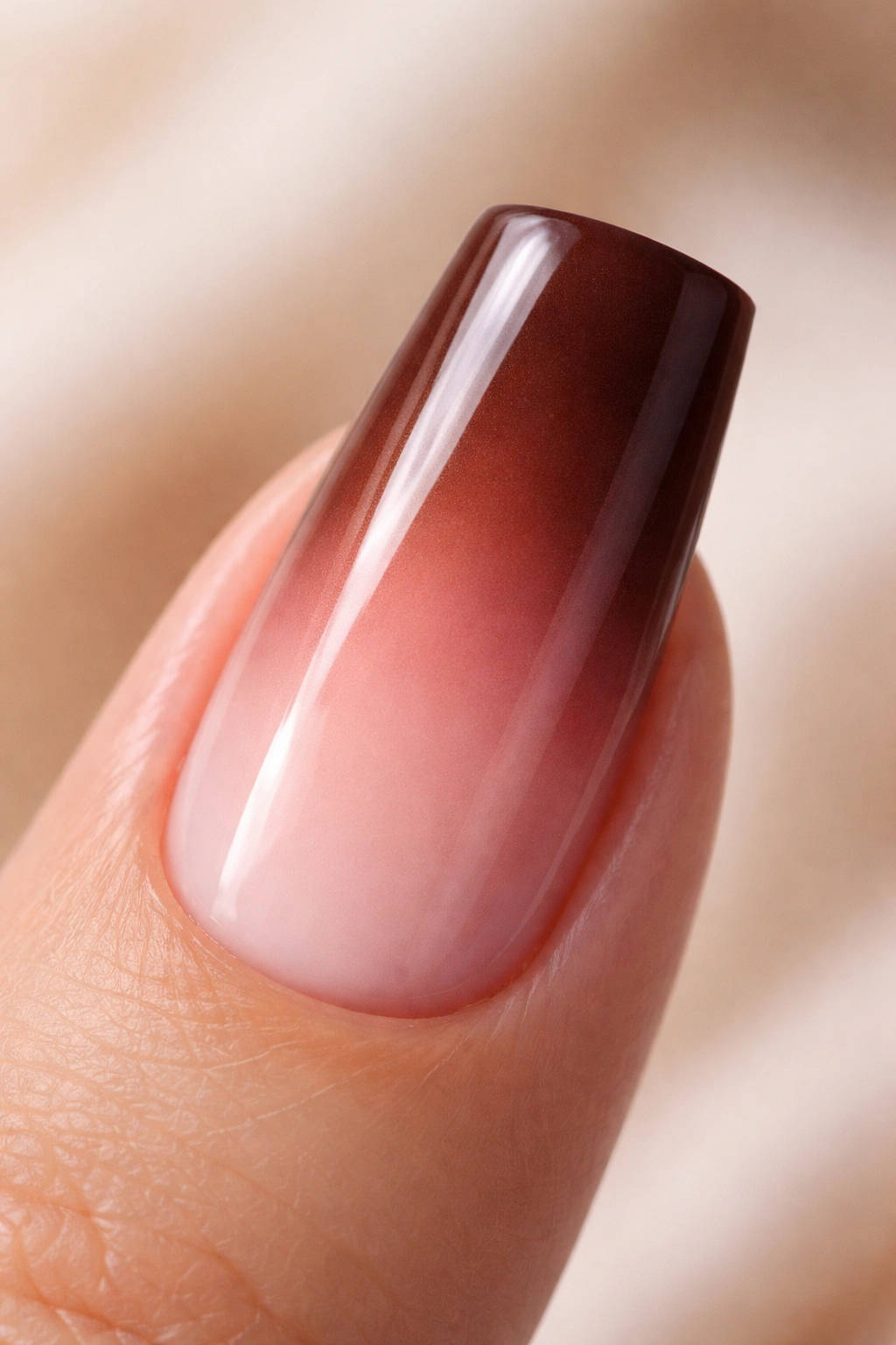 Close-up of a duck nail gradient from chocolate brown to blush pink