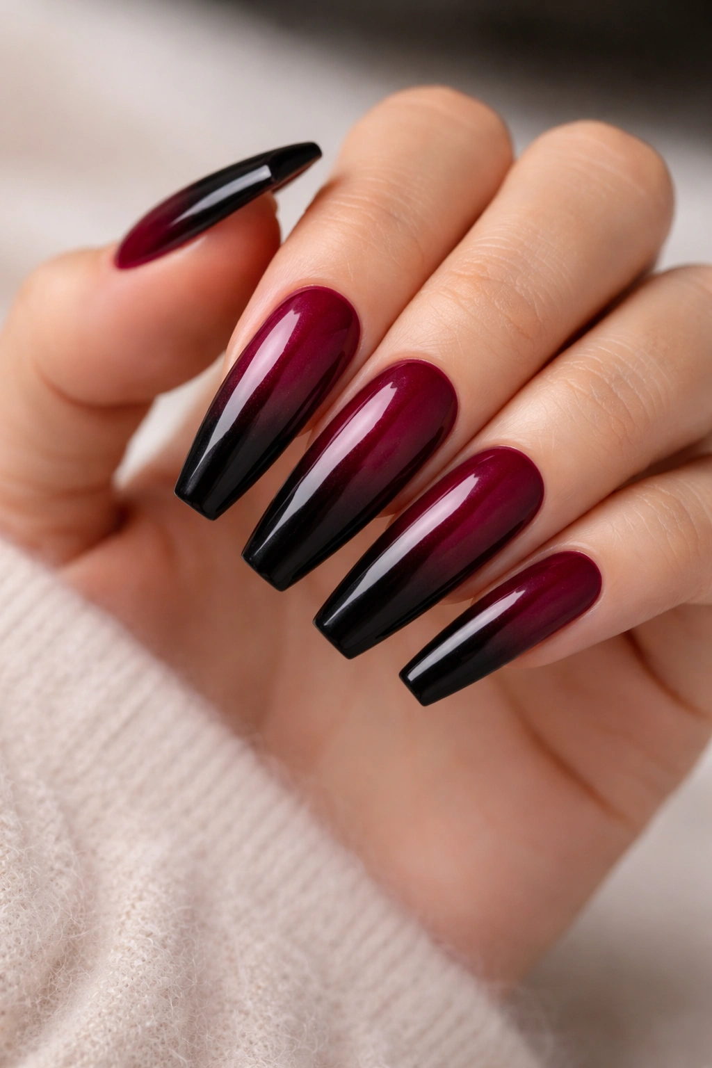 Close-up of burgundy to black gradient coffin nails