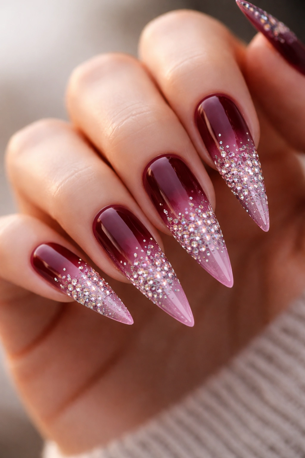 Ombre burgundy stiletto nails with rhinestone gradient at tips